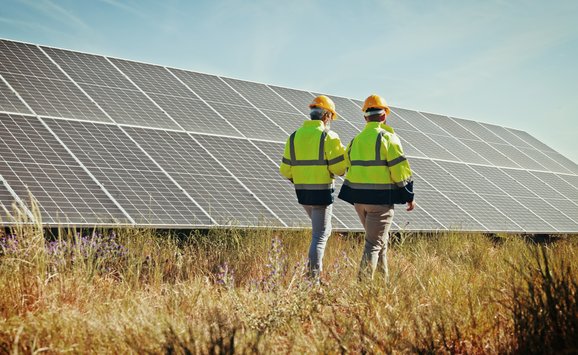 engineers inspecting solar panels / shutterstock_2557820731